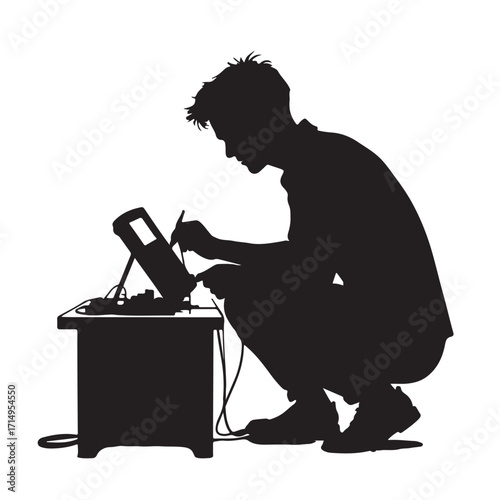 Person crouching working with electronic device silhouette
