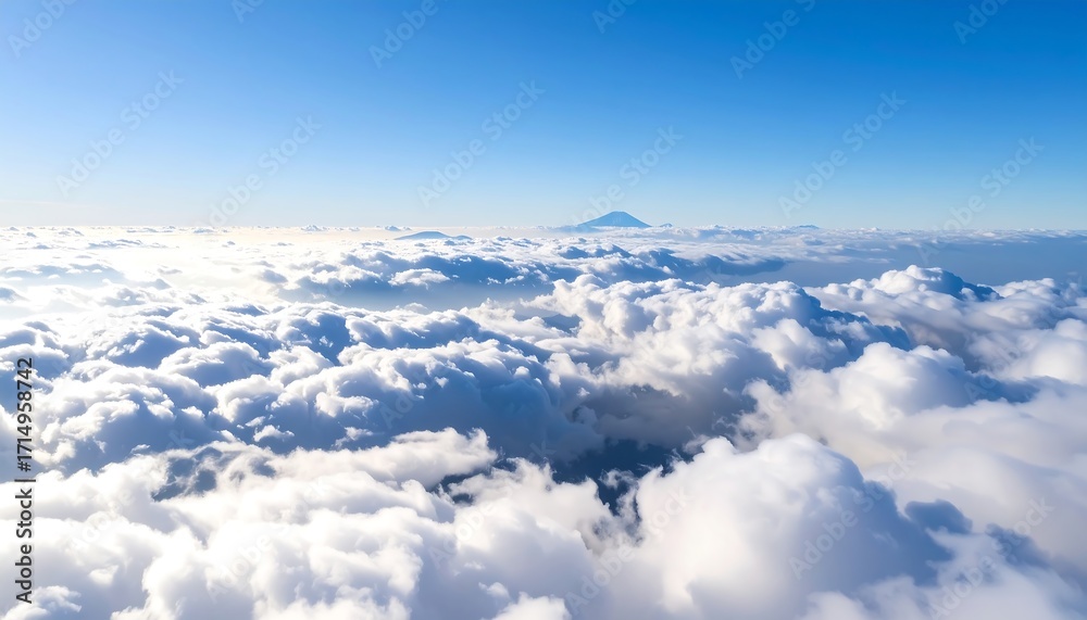 Naklejka premium High-altitude view of clouds and a mountain peak