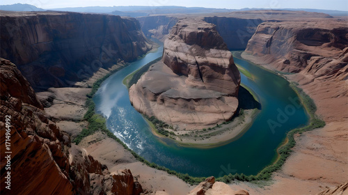 Aerial view of a majestic river carving a dramatic horseshoe bend through a deep, red rock canyon