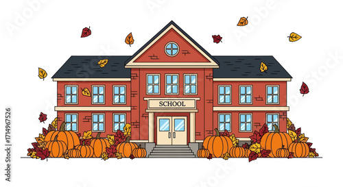 Red brick school building decorated for autumn with pumpkins and falling leaves.