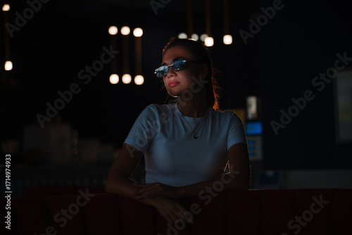 Obraz na plátne portrait of a beautiful girl in a dark night bar photo with low key lighting
