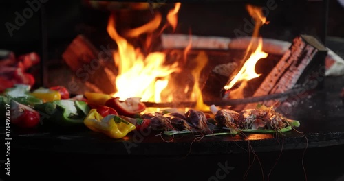 Langoustines with vegetables on the grill against a backdrop of flames, slow motion
