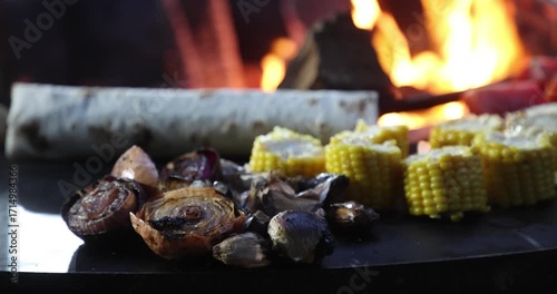 Grilled sliced onion and corn being cooked at a street food festival
