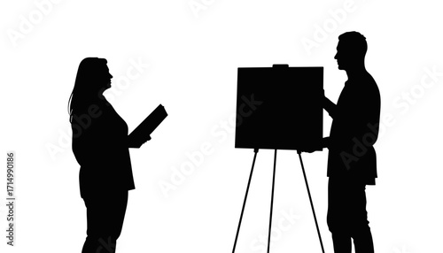 Woman listening while man presenting on easel in silhouette  