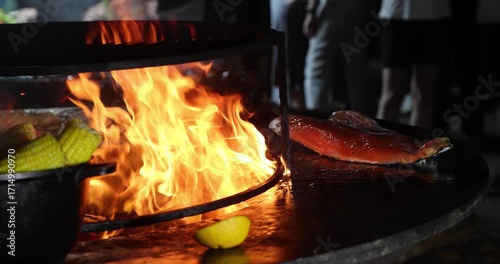 Large piece of red fish grilling at a street food festival