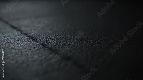 Closeup of Textured Black Surface with Subtle Lighting Effects