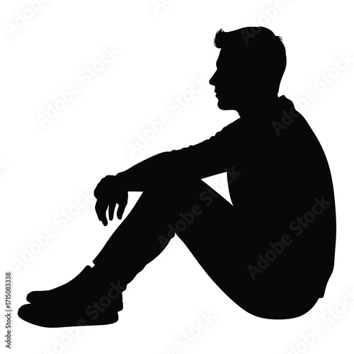 A seated man in a thoughtful pose a striking black silhouette