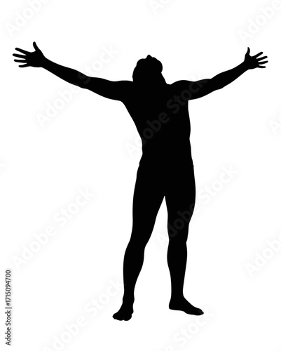Silhouette of a man standing with arms outstretched looking upwards in a pose of triumph or surrender
