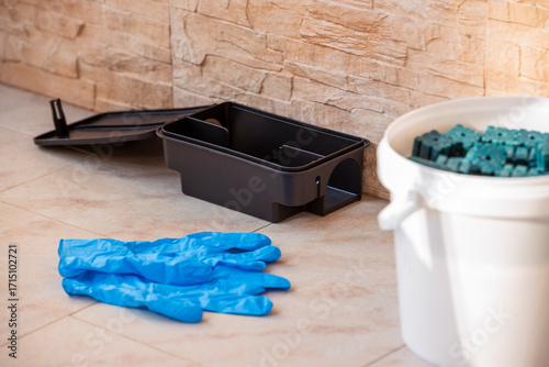 Pest control bait station with rodenticide and safety gloves