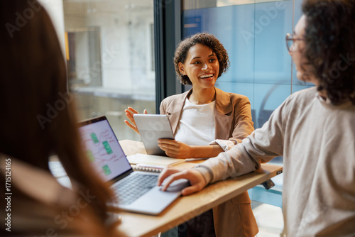 A casual yet professional meeting among colleagues in a chic and stylish office environment that encourages creativity