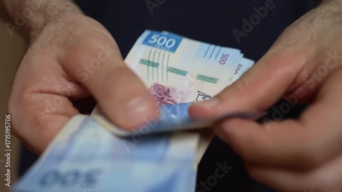 Close up of hands counting bills, Mexican mxn peso banknotes, financial transaction and cash handling concept. Money management, economy, finance, savings, spending, and everyday commerce in Mexico