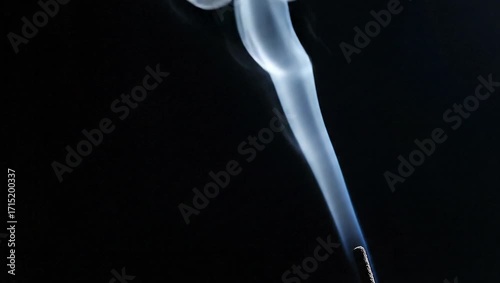 Wallpaper Mural Smoke Stream: A wisp of smoke curls gracefully against the darkness, showcasing the ethereal dance of matter and energy in a minimalistic composition.  Torontodigital.ca