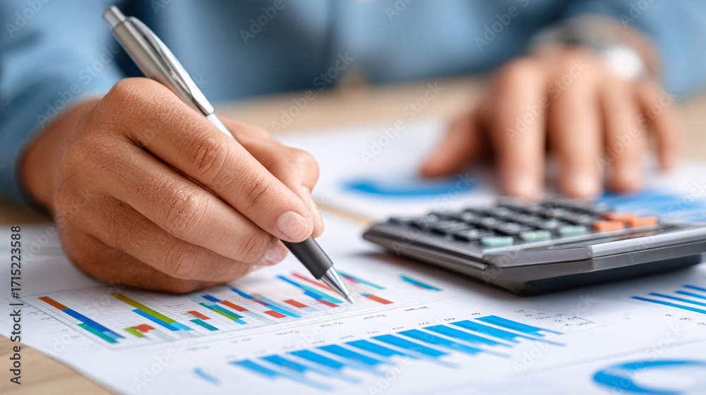 Fototapeta premium Business Professional Analyzing Financial Data With Graphs and Calculator on a Desk