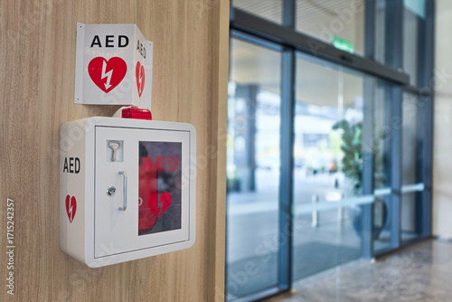 AED or Automated External Defibrillator installed on wall in hotel lobby as first aid in heart attack emergency situation.