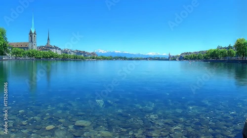 Picturesque Zurich Panorama Across the Crystal-Clear Limmat River with the Alps in the Distance.