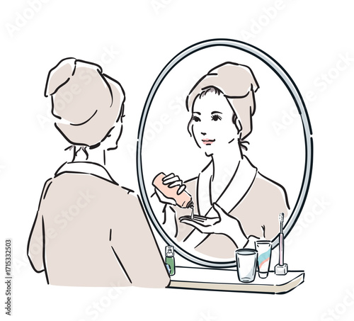 鏡の前に立つバスローブ姿の女性　スキンケア