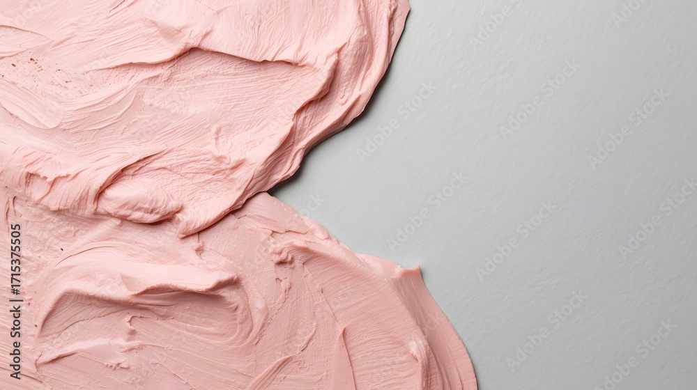 Fototapeta premium Abstract close-up of smooth pastel pink creamy texture spread on gray surface, representing beauty cosmetic background, skincare product, paint art surface, minimalism, and luxury design concept for c