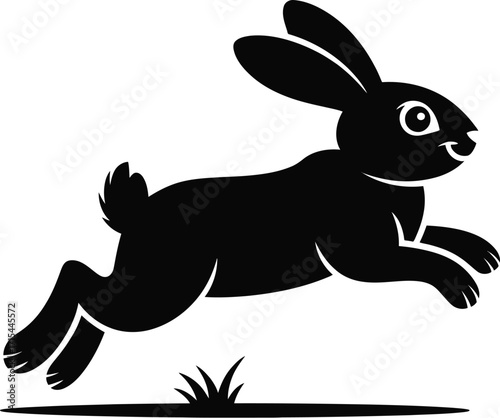 Black rabbit leaping through grass silhouette jumping