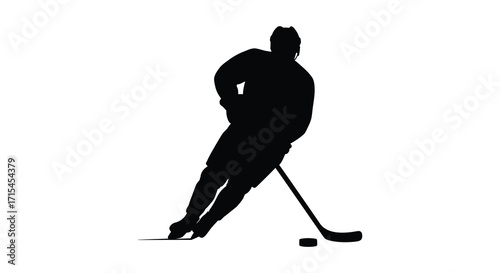 Silhouette of a hockey player in action with puck and stick