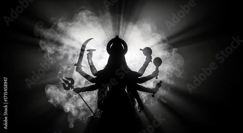 Wallpaper Mural Hindu Goddess Silhouette with Multiple Arms and Trident in Smoke. Navratri with the ethereal image of Durga Mata, a symbol of creation, power, and the protector of the universe in one frame. Torontodigital.ca
