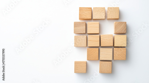Set of cubeshaped wooden blocks arranged randomly on white background, creating playful and creative atmosphere