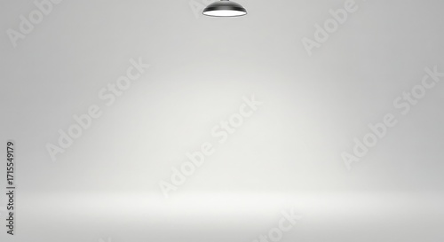 A clean, empty studio with a single spotlight illuminating the floor, creating a soft gradient.