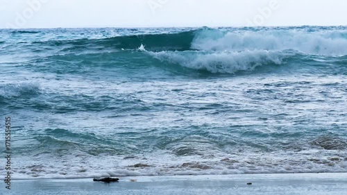 Seascape dark ocean background wave splash on rock. Tropical sea beach in summer seaside outdoor. Water Surface blue wave pattern. Turquoise ocean sea water white wave pattern splashing deep blue sea