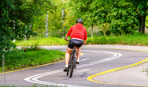Wallpaper Mural Cyclist ride on the bike path in the city Park
 Torontodigital.ca