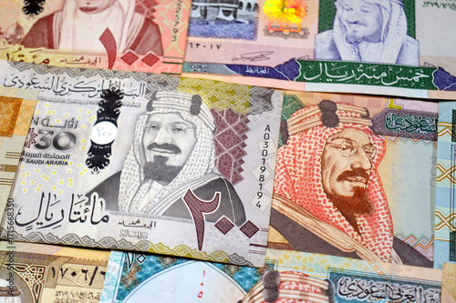 Saudi Arabian riyals SAR banknotes cash money bills, of different times, eras and values, from old vintage retro King Fahd times till king Salman time, Saudi Arabia riyals money and economy concept