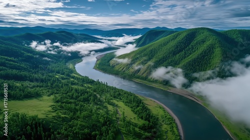 Aerial View of Lush Green Mountains Surrounding a Serene River with Soft Morning Fog
