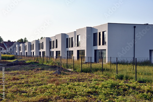 Green field and newly constructed, modern residential buildings in Wroclaw, Poland.