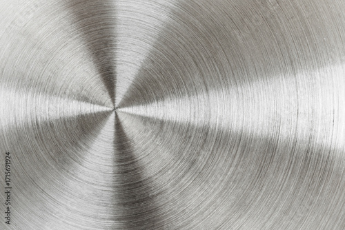 Circular brushed metal texture, silver metallic background.