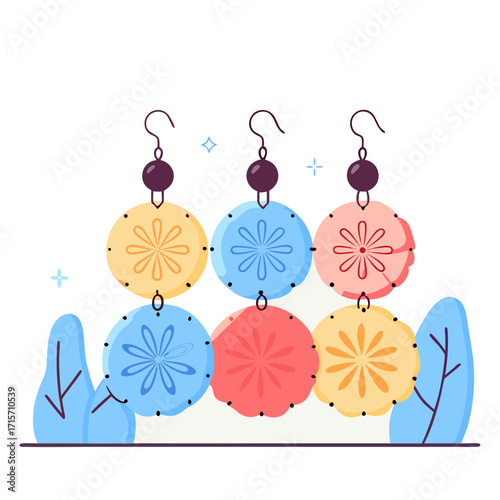 Colorful pompom earrings hanging against a minimalist background  
