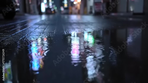 Wallpaper Mural Urban Rain: Colorful Neon Lights Reflecting on Wet City Street Puddles at Night with Falling Raindrops and Blurred Cityscape Background Torontodigital.ca