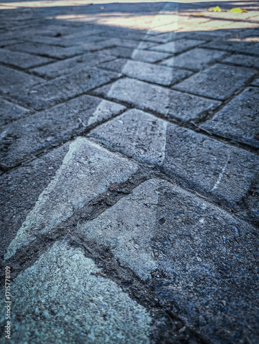 Diagonal white line across rough stone path