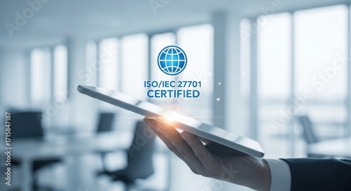 Professional demonstrates data security certification on a digital tablet in a modern office.