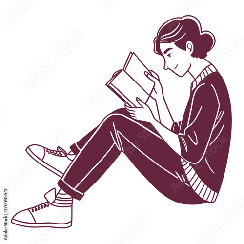 Young woman sitting cross legged on the floor engrossed in reading a book with a smile