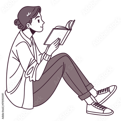 Young woman sitting on the floor with legs crossed reading a book with a smile