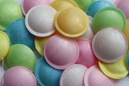 Fotografie Flying saucer UFO shape sweet colorful candies on white background