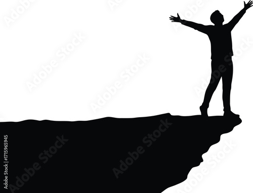 Silhouette of person with arms outstretched on a cliff edge