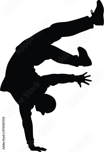 Silhouette of a Dancer Performing a Breakdancing Move