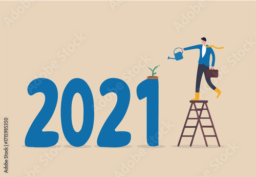 Year 2021 economic recovered from COVID-19 Coronavirus outbreak, business grow up from government stimulus policy concept, businessman watering seedling plant grow from year number 2021.