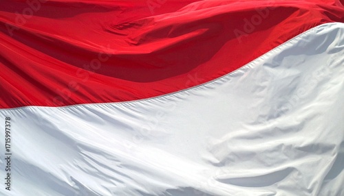 Indonesian flag with red and white horizontal bands fluttering—simple geometry and symbolic colors evoke courage, purity, and national dignity in timeless sovereign composition.
