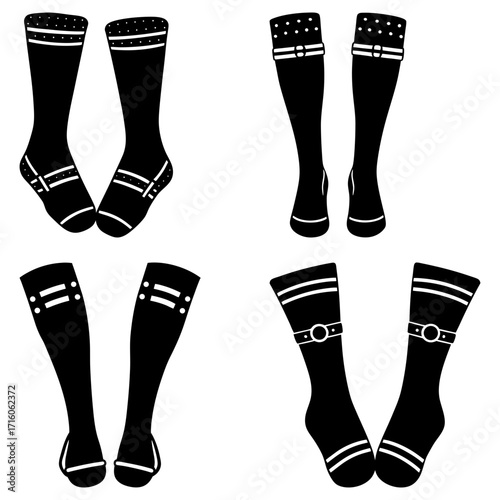 Four pairs of black socks with different designs including stripes dots and buckle accents on white background