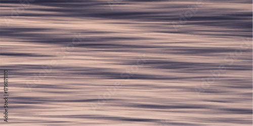 Sunset light ripples across the sea, reflecting a beautiful blue sky and clouds.