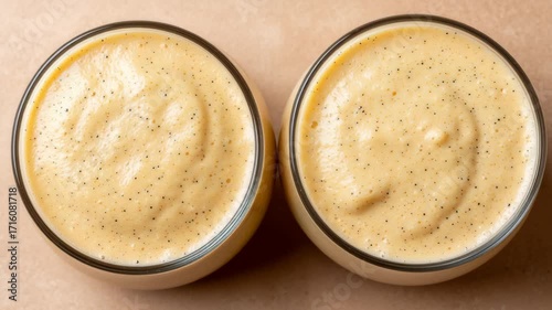 Creamy Vanilla Pudding in Elegant Glass Bowls on Neutral Background with Subtle Texture