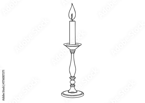 Traditional candle with flame on a vintage candlestick holder  