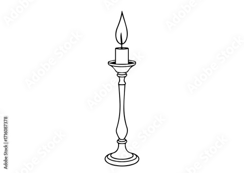 Classic candle in ornate holder with flame illuminating softly  