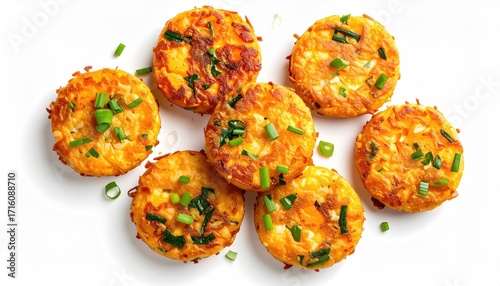 Six golden-brown, small, round fritters, possibly corn or potato based, garnished with finely chopped green onions, arranged on a white background
