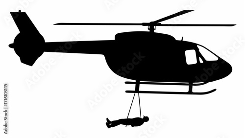 Silhouette of a helicopter with rotating blades and a person suspended below on a rope rescue operation